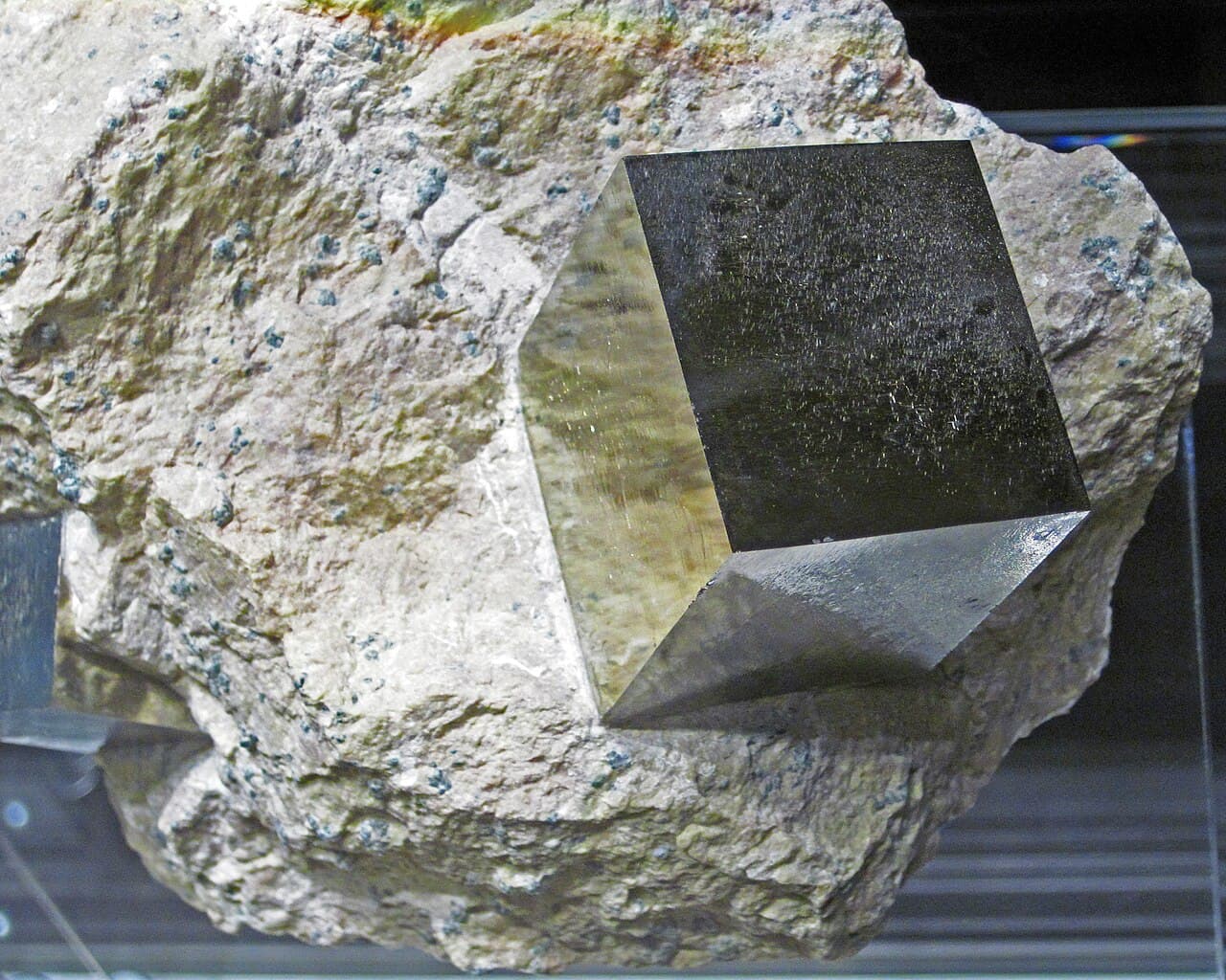 Pyrite — cubic crystal with striated faces in matrix